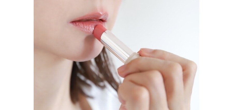 口紅を塗っている女性の口元